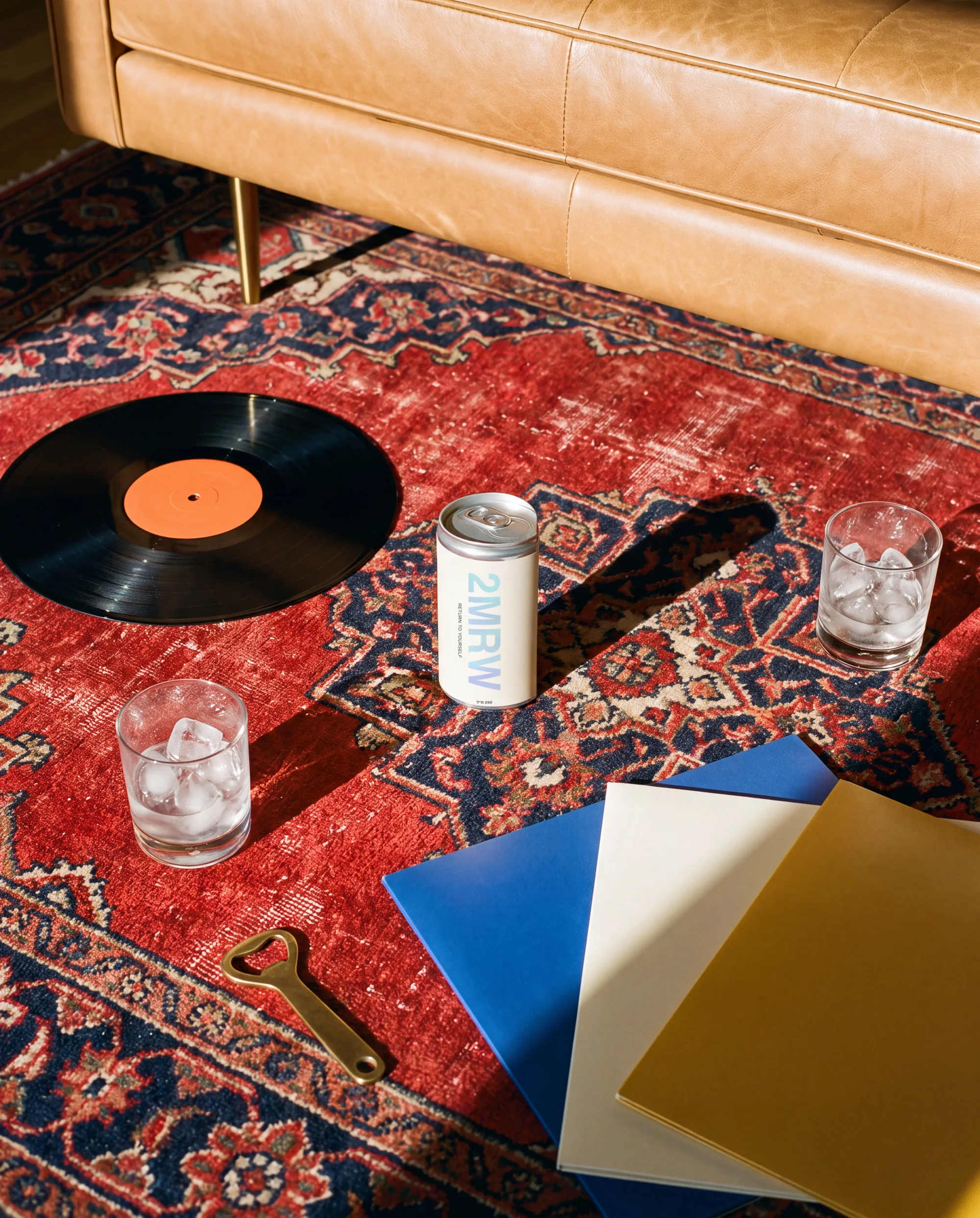 A 2MRW can standing on a red Persian rug with a record, two glasses of ice and record sleeves