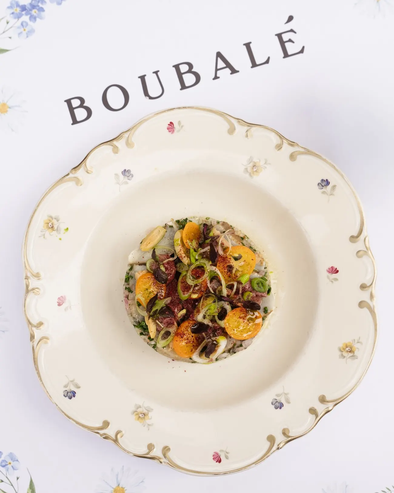 A dish plated on folk-patterned china