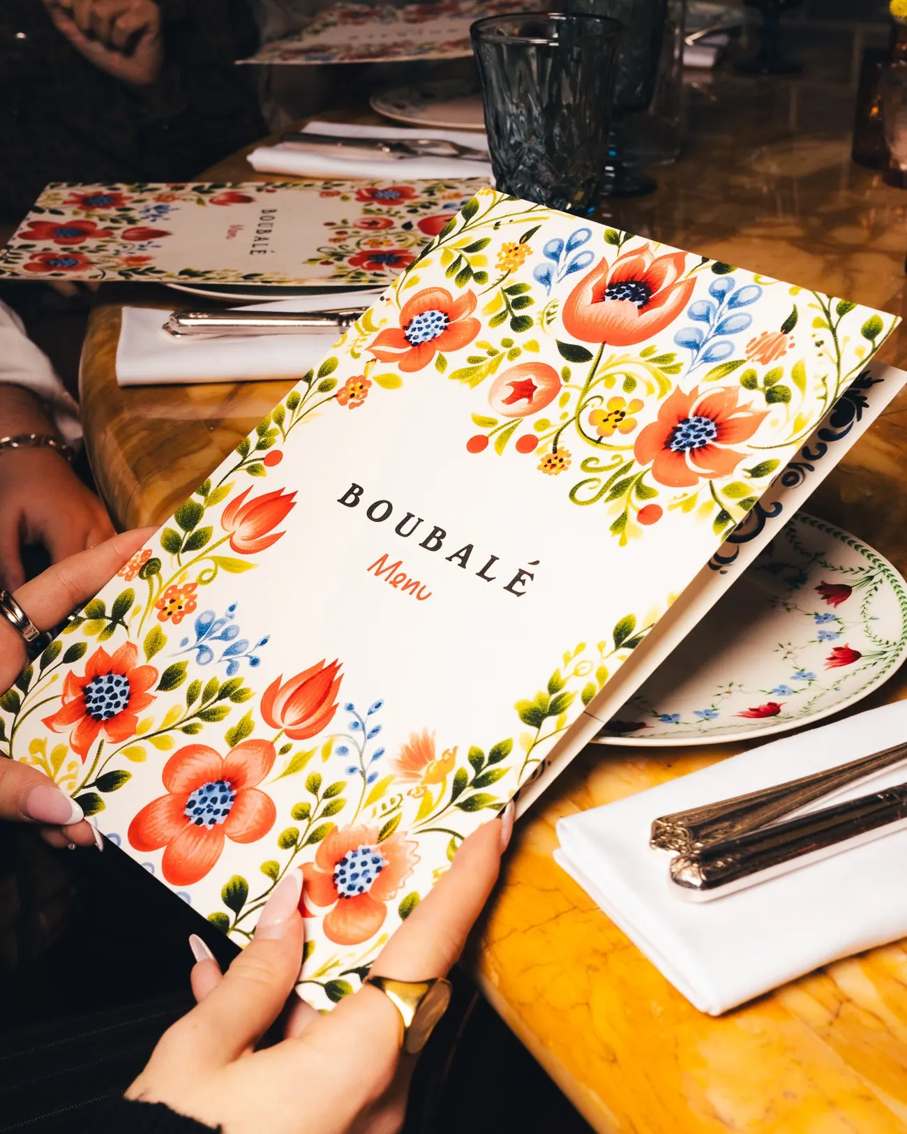 A guest holding the menu at the table