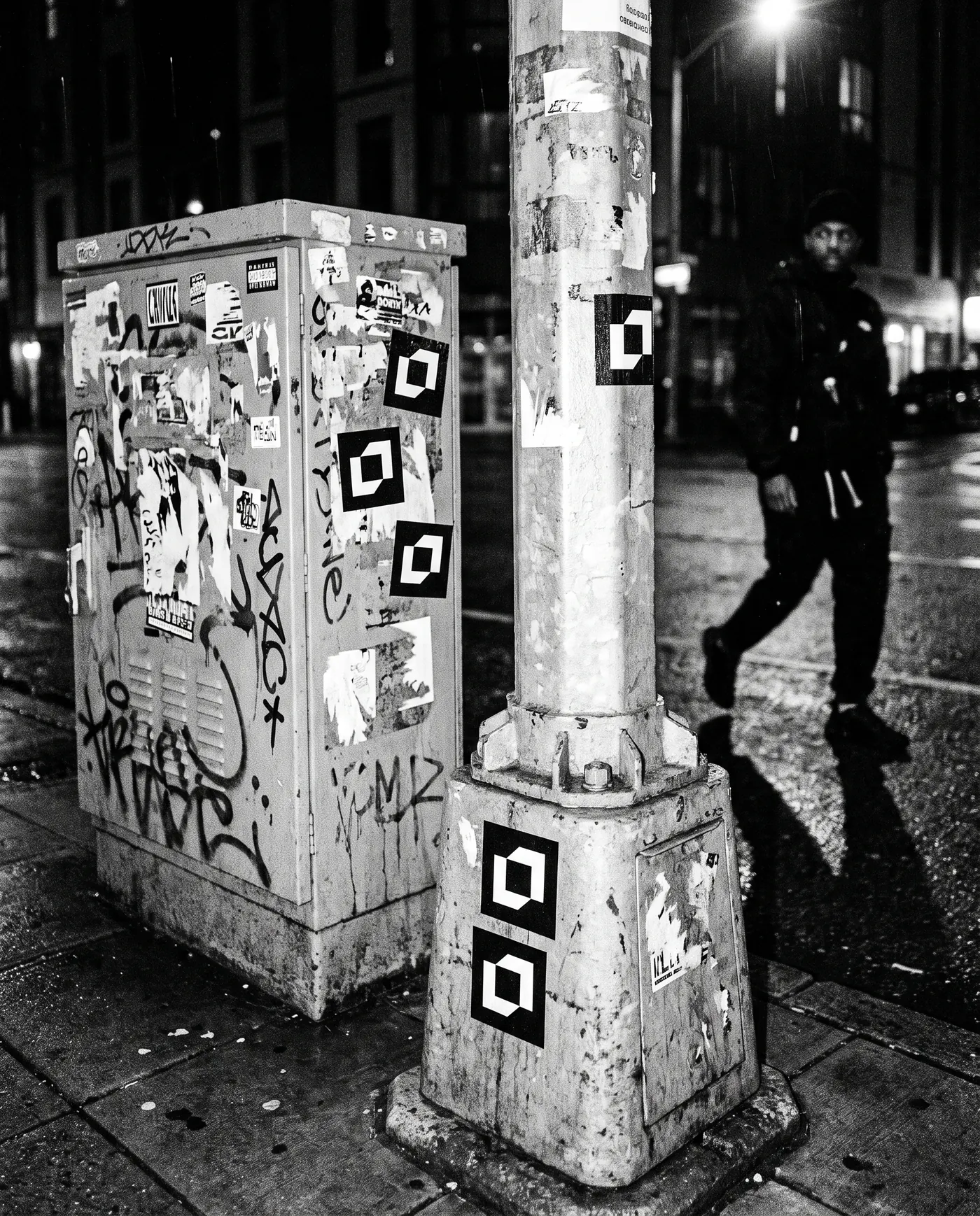 Symbol stickers on a lamp post at night