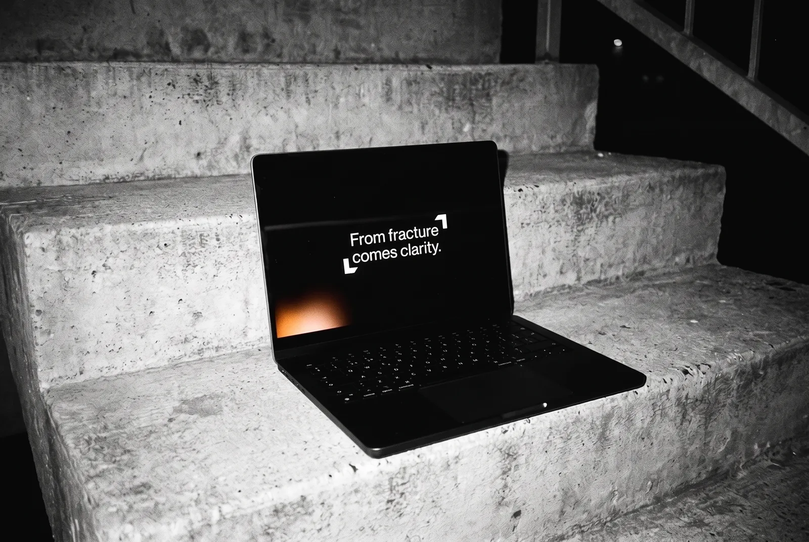A slide template on a laptop on concrete steps: From fracture comes clarity.