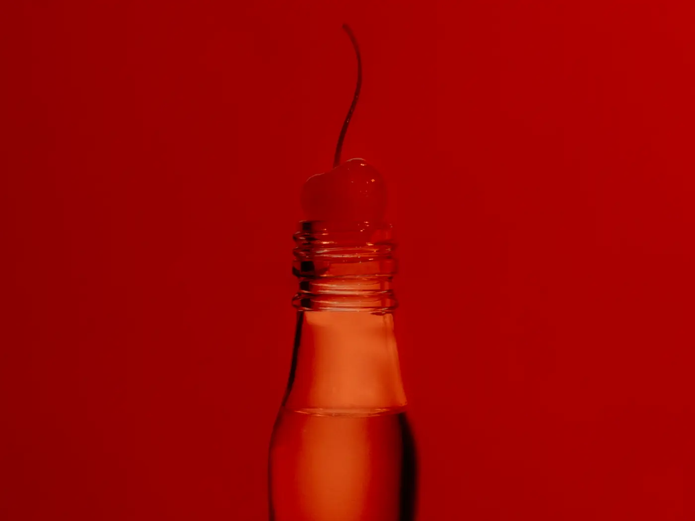 The Sok&oacute;ł bottle in silhouette against a saturated red wall