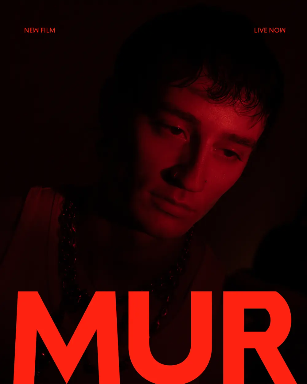 Rollout poster: a face lit red in near darkness with MUR across the lower third, labelled NEW FILM and LIVE NOW