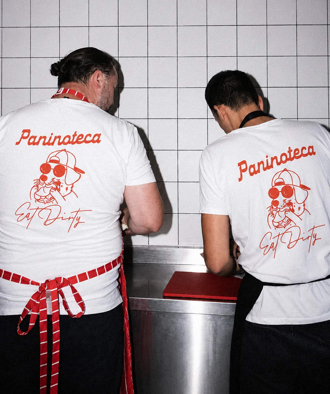 Kitchen staff in branded uniform.