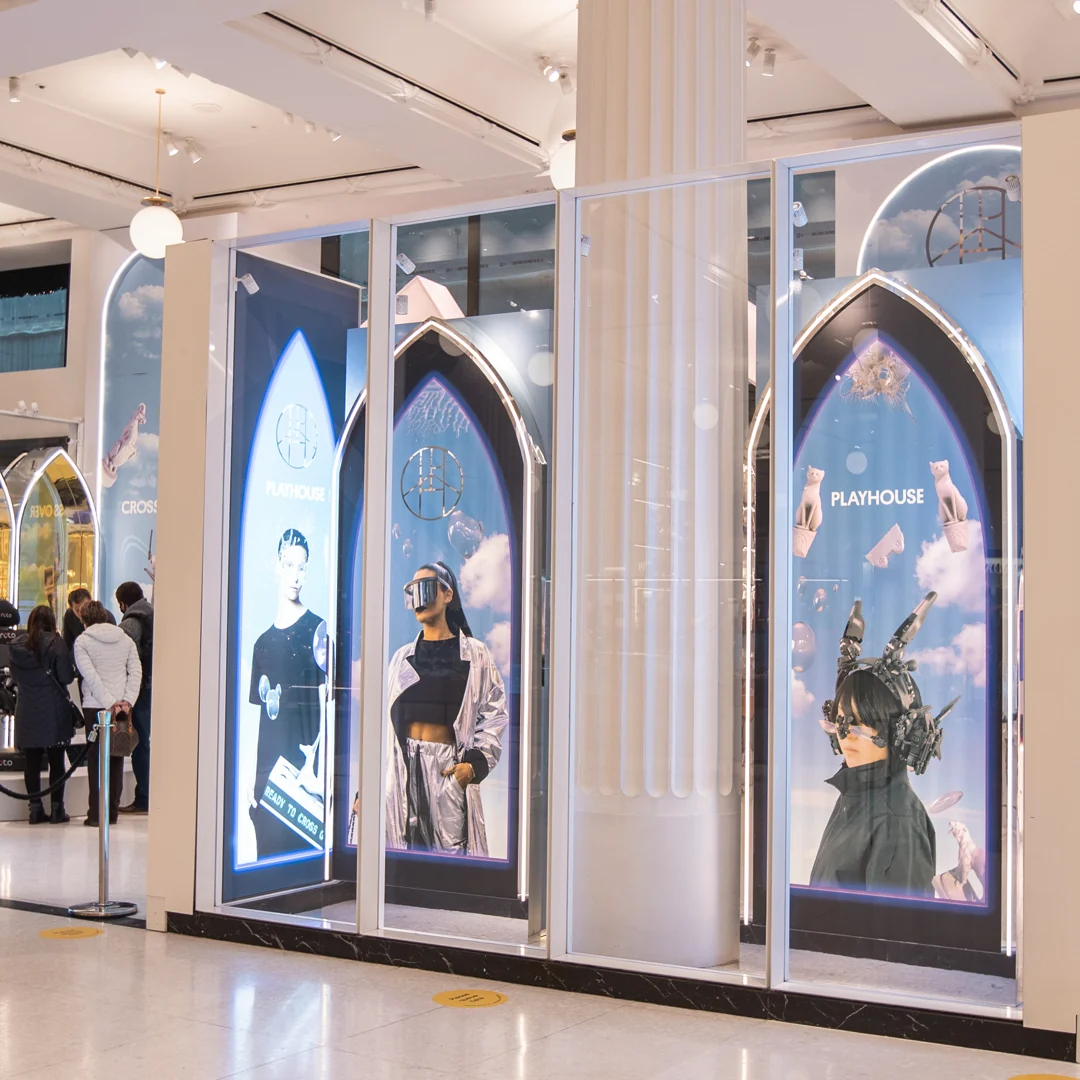 The store front at Selfridges: arch-shaped screens showing the campaign portraits