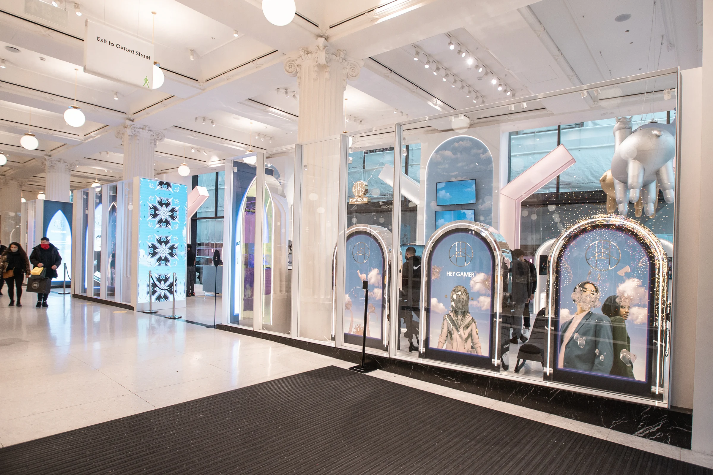 The Playhouse store from the shop floor: a row of white arches with the campaign running on every screen