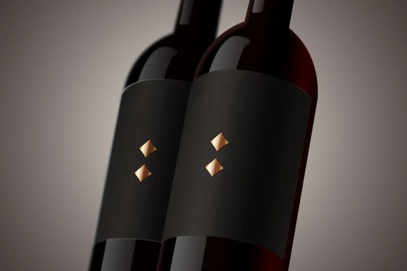Two bottles with black labels and gold lozenge studs